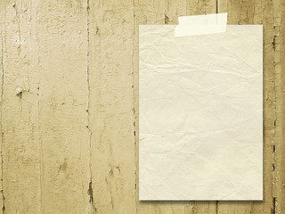 Wall Mural - Close-up of one paper sheet with tape on light brown wood background