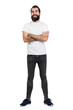 © sharplaninac - Happy positive bearded hipster in white t-shirt and tight jeans with crossed arms. Full body length portrait isolated over white studio background.