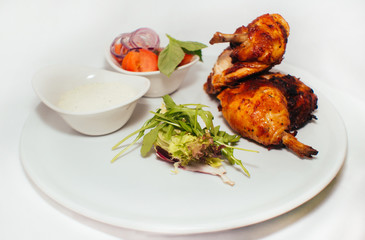 Fried chicken legs with salad from vegetables and greens with white sauce