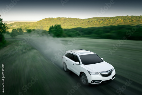 Fotografia, Obraz Modern car fast drive on dirt road at sunset