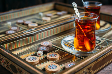 Turkish sweets and tea on the backgammon Board