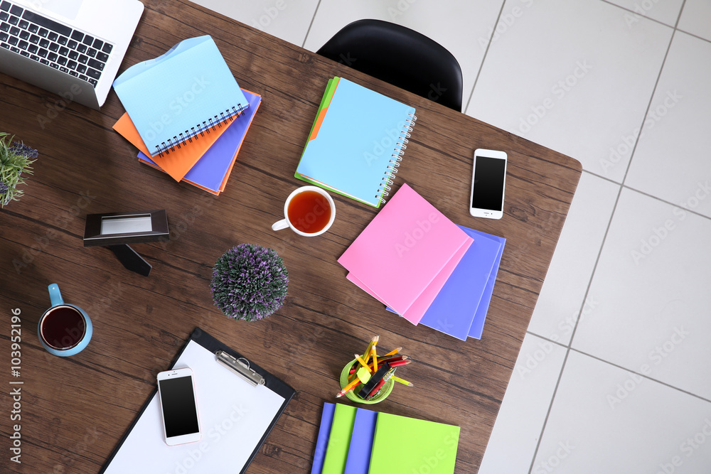 Session concept. Table with tablet, laptop, papers and cups of tea. Top view.