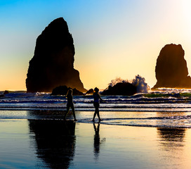 Wall Mural - People walk at sunset on the beach in the wild Pacific Northwest