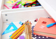 © Africa Studio - Stationery in open desk drawer closeup