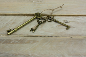 Antique keys on wooden background