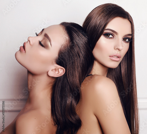 Plakat studio mody zdjęcie dwóch pięknych młodych kobiet o ciemnych włosach, pozowanie razem
