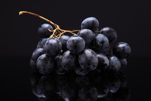 Closeup Image Of Black Grapes On Black Background With Reflectio