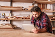 © mavoimages - Woodwork craftsman in his studio using a digital tablet