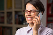 © punghi - Attractive young woman with glasses talks on her smartphone