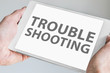 © iconimage - Troubleshooting text displayed on touchscreen of modern tablet or smart device.