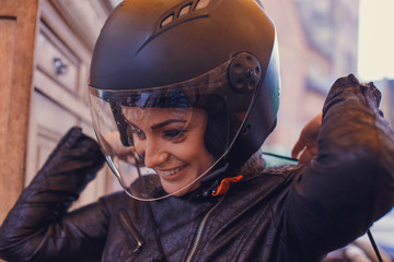 A woman wearing a moto helmet.