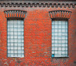 Two old windows with square glass blocks in old worn down factory building