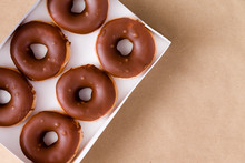 Top Down View Of Chocolate And Cream Donuts In Box