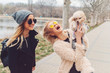 © sergiubirca - two young caucasian cute girls portrait with dog outdoor in park walking happy and smile all the way