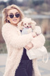 © sergiubirca - young caucasian cute girl portrait with dog outdoor in park walking happy and smile all the way