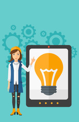 Poster - Woman pointing at tablet computer with light bulb on screen.