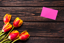 Tulips And A Card On A Wood