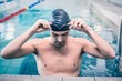 © WavebreakmediaMicro - Handsome man wearing swim cap and goggles