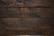 Dark brown rustic  aged barn wood planks background. Space for text, copy, lettering.