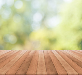 Wall Mural - Wooden table top on blurred green background - used for display your products