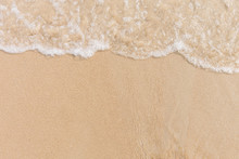 Soft Wave Of The Sea On The Sandy Beach With White Clean Foam. Copy Space