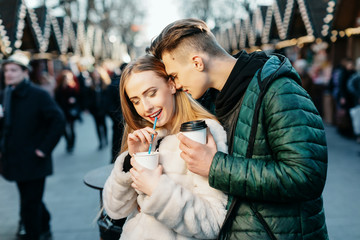 Attractive couple standing together at Christmas market