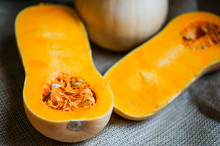 Uncooked Sliced Butternut Squash On Wooden Background