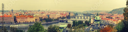 Panoramic view of old beautiful Prague city with red roofs and bridges through t Poster