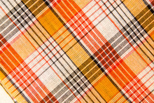 The Texture Of White Checkered, Orange, Red, Black Cotton Fabric