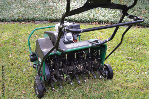 Fotografia, Obraz Lawn aeration machine with grass plug stuck in the stem