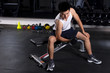 © zhu difeng - young man working out in modern gym