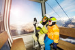 © Sergey Novikov - Mom talk to child sitting in ski lift cabin