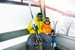 © Sergey Novikov - Father and son in ski lift cabin