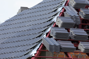 Wall Mural - black tile roof on residential building construction house