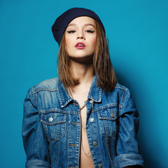 Closeup studio shot of pretty hipster teenage girl with beanie h