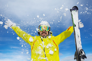 Wall Mural - Happy skier man throw snow over sky