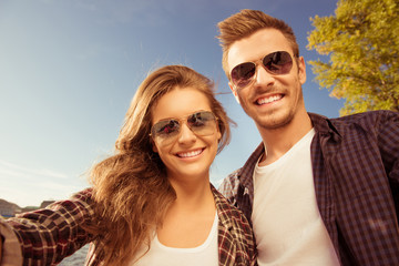 Sticker - Happy couple in love in glasses making selfie