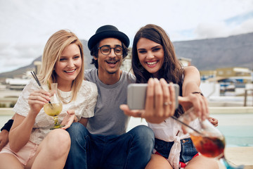 Wall Mural - Best friends in party capturing the moment on camera