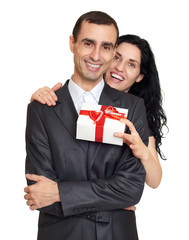 Wall Mural - Couple with gift box, studio portrait on white. Dressed in black suit.