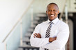 © michaeljung - african office worker with arms crossed