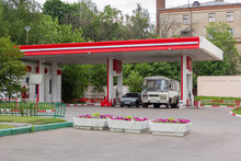 Bus And Car Refuel At Gas Station