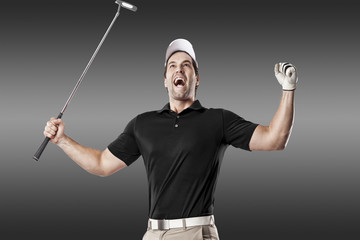 Wall Mural - Golf Player using a black uniform.