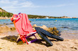 deckchair with diving mask and flipper, on the beach, sunny day.