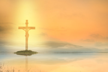 Wall Mural - Silhouette Jesus and the cross over sunset on lake