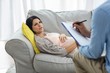 © WavebreakmediaMicro - Doctor writing on clipboard while consulting pregnant woman