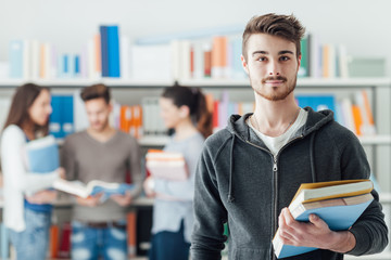 Wall Mural - Confident student posing in the library