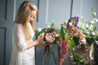 © cherry_d - Florist at work: pretty young blond woman making fashion modern bouquet of different flowers