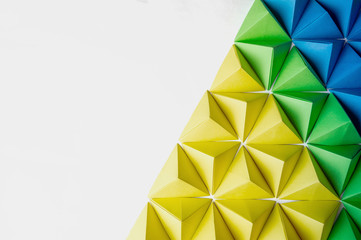 Wall Mural - Origami 3 dimension shapes in green, blue and yellow colors with free copy space on the left side. Great for using in web.