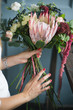 © cherry_d - Florist at work: pretty young blond woman making fashion modern bouquet of different flowers