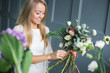 © cherry_d - Florist at work: pretty young blond woman making fashion modern bouquet of different flowers